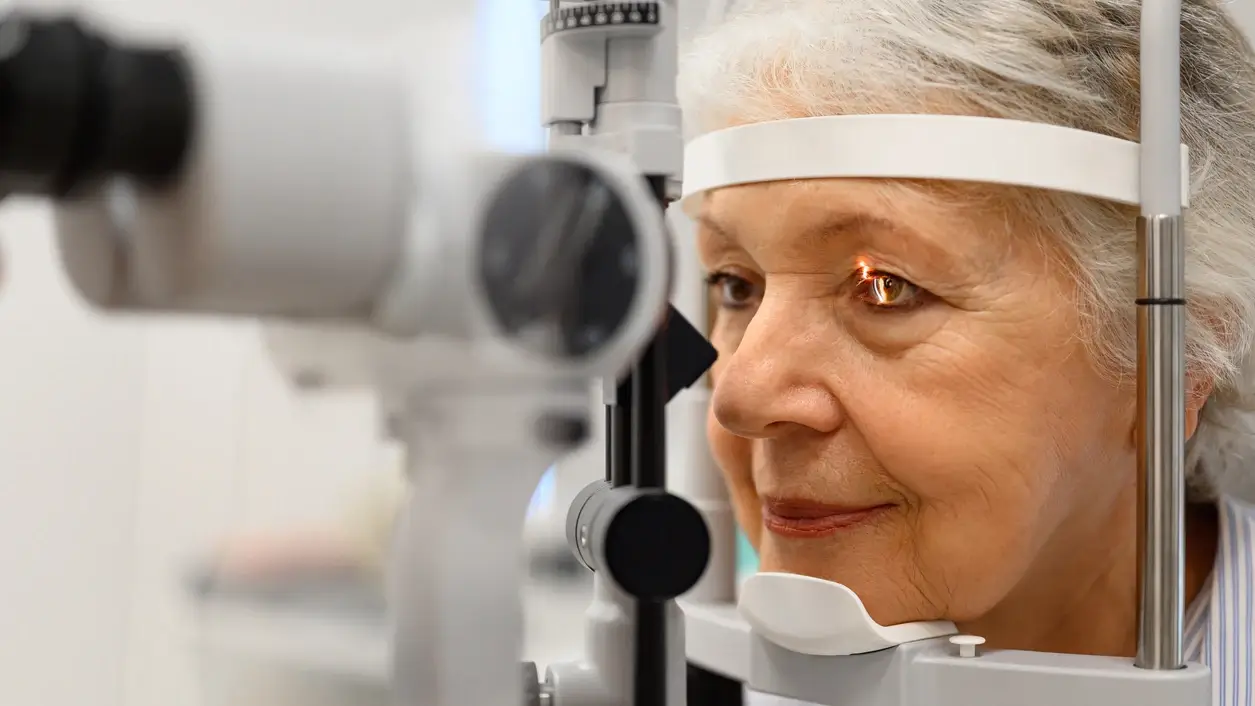 Optometrist performing a dilated eye exam on a patient